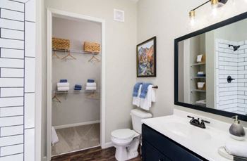 a bathroom with a sink and a toilet and a mirror at Essex, Columbus